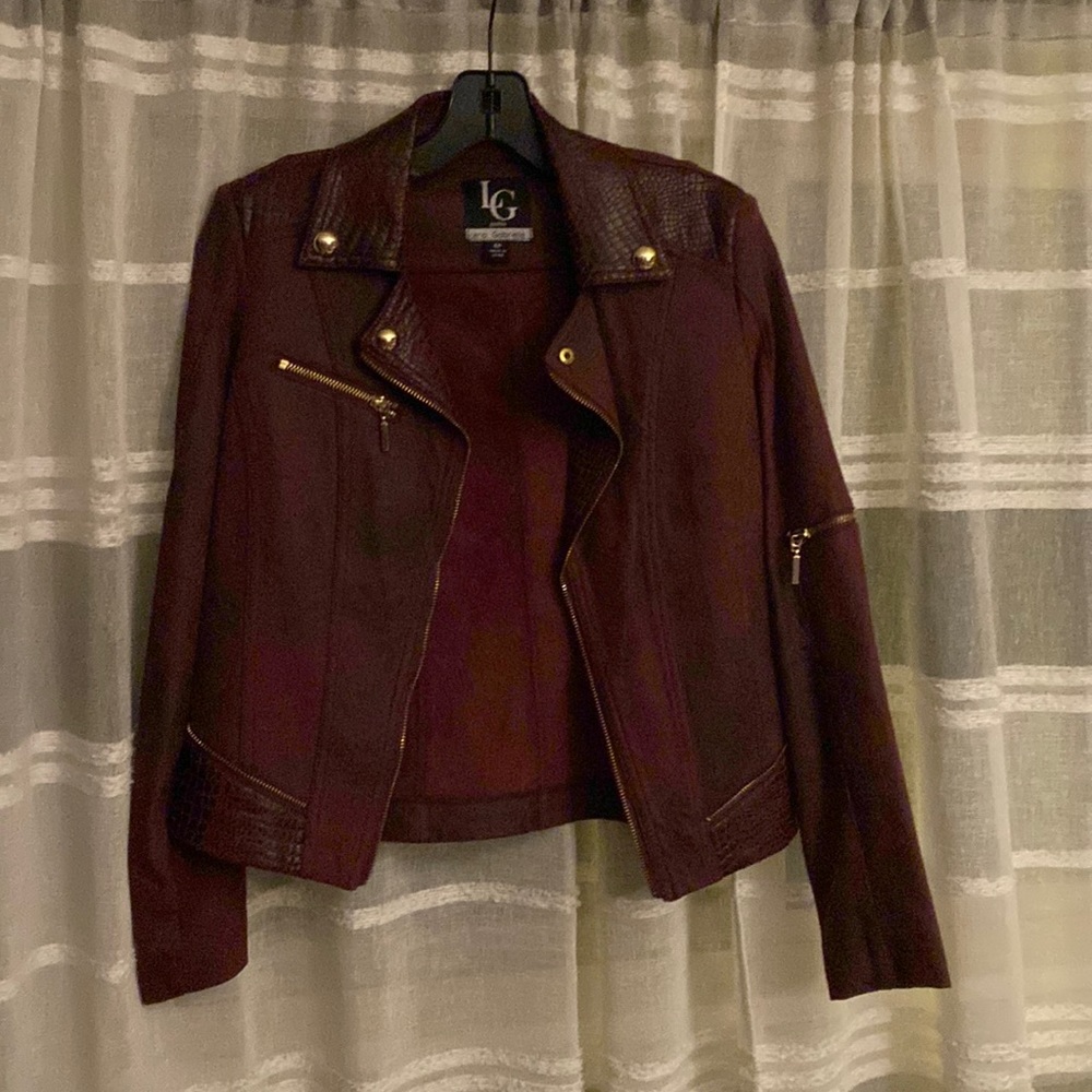 Moto burgundy jacket with decorative zippers add an edgy finish. Faux suede.